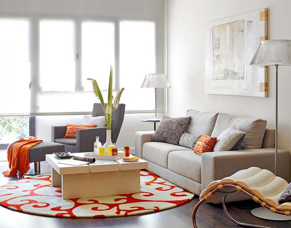 Được đặt ở sát khung cửa kính, phòng khách hiện lên chan hòa ánh sáng. Cách phối màu tươi sáng với màu trắng của tường, đồ nội thất trắng xám làm chủ đạo. Nổi bật là chiếc thảm có họa tiết màu đỏ trắng tươi tắn, càng bắt sáng tốt hơn cho không gian này Nhà đẹp