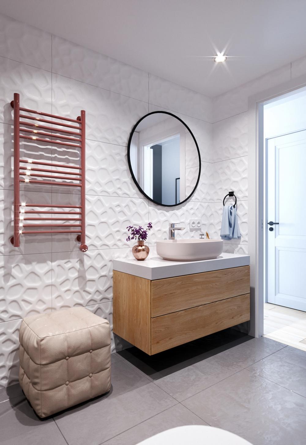 Gạch ốp tường họa tiết nổi giúp không gian có chiều sâu hơn, trong khi chiếc gương tròn tạo cảm giác phòng tắm rộng hơn thực tế trang trí phòng tắm