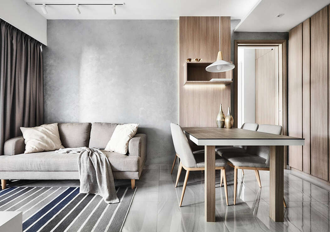 Căn hộ Scandinavian màu xám trắng trang nhã. Không gian căn hộ với nội thất màu xám, ghế sofa đặt cạnh bàn ăn nhỏ