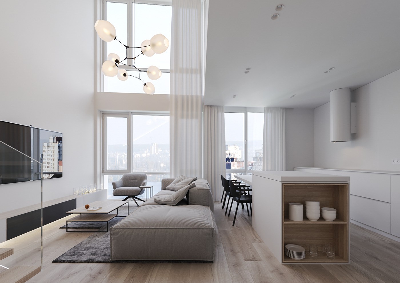 Phòng bếp gọn gàng với đảo bếp đa chức năng. Sofa xám cạnh cửa sổ, bên phải là đảo bếp màu trắng kết hợp bàn ăn và kệ lưu trữ.